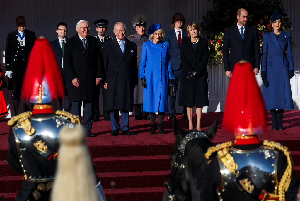 On the stage from left, German President Frank-Walter Steinmeier, Britain's King Charles III, Queen Camilla, wife of Steinmeier Elke Buedenbender, Prince William and Kate, Princess of Wales, attend a welcome ceremony on the Royal Dais at Datchet Road, in Windsor, England, Wednesday, Dec. 3, 2025. (Toby Melville/Pool Photo via AP)