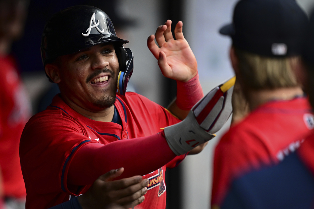 Atlanta Braves' Nacho Alvarez Jr. is congratulated in the dugout after scoring on a two-RBI double by Nick Allen during the second inning of a baseball game against the Cleveland Guardians, Saturday, Aug. 16, 2025, in Cleveland. (AP Photo/David Dermer)
