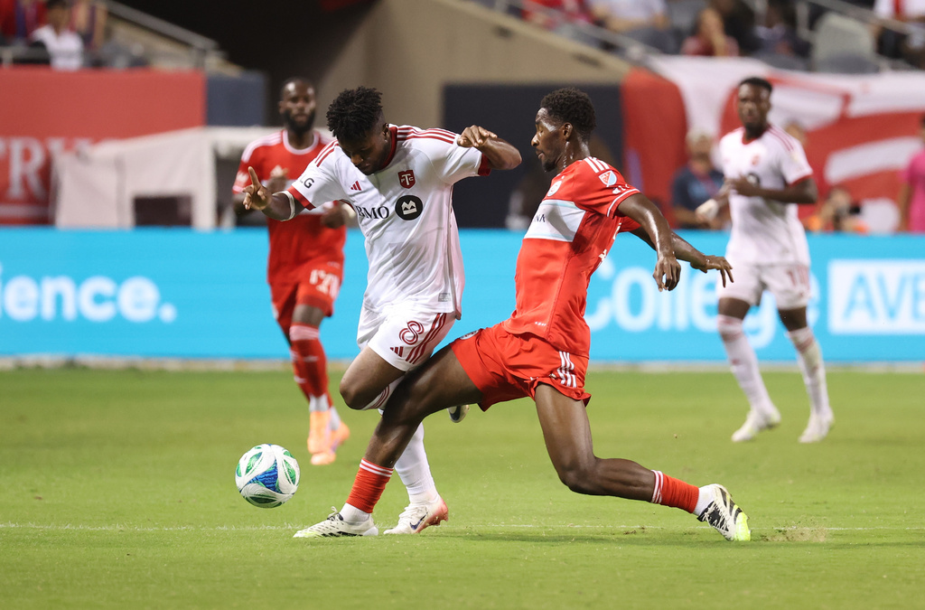 Toronto FC midfielder Matthew Longstaff (8) and Chicago Fire midfielder D'Avilla Dje Tah, right, battle for control of the ball during the second half of an MLS soccer match Saturday, Oct. 4, 2025, in Chicago. (AP Photo/Talia Sprague)
