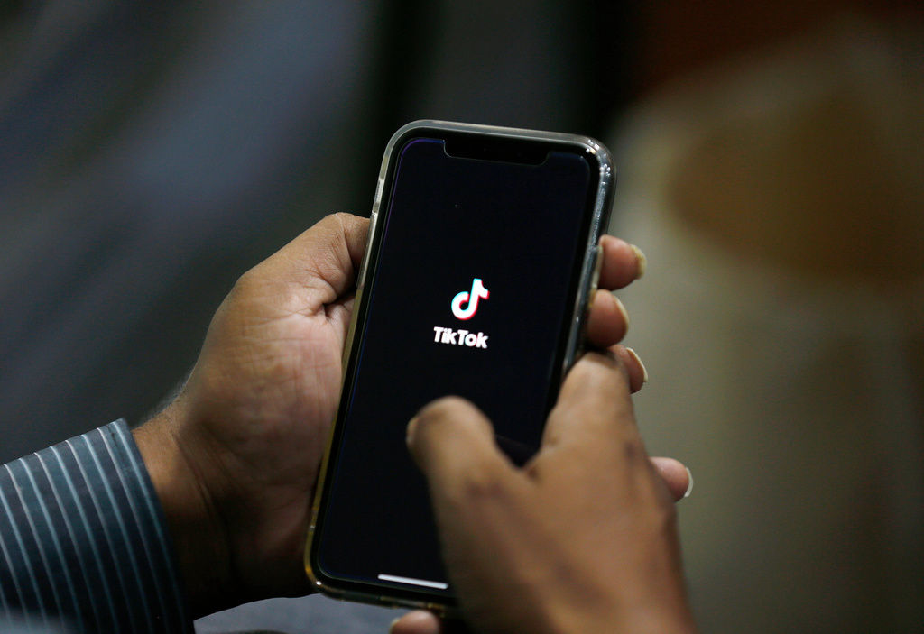 FILE - In this July 21, 2020 file photo, a man opens social media app 'TikTok' on his cell phone, in Islamabad, Pakistan. (AP Photo/Anjum Naveed, File)