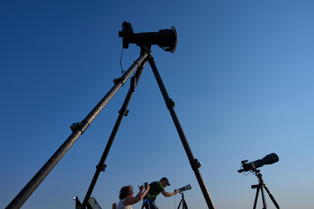 Members of the "Los Taraos" amateur astrophotography group, set up cameras to shoot a total solar eclipse in Berlanga de Duero, central Spain, Wednesday, Aug. 12, 2026. (AP Photo/Bernat Armangue)
