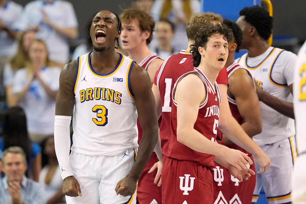 UCLA guard Eric Dailey Jr., left, celebrates after scoring as Indiana guard Conor Enright look on during the first half of an NCAA college basketball game, Saturday, Jan. 31, 2026, in Los Angeles. (AP Photo/Mark J. Terrill)