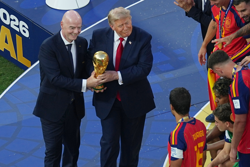 FIFA President Gianni Infantino and President Donald J. Trump present the trophy to Spain's Rodri (16) after the World Cup final soccer match between Spain and Argentina in East Rutherford, N.J., near New York, Sunday, July 19, 2026. (AP Photo/Matt Rourke)