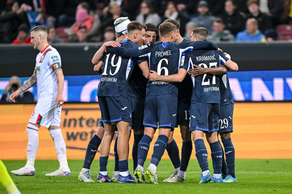 Hoffenheim's Bazoumana Toure celebrates with teammates after scoring during the German Bundesliga soccer match between FC Augsburg and TSG 1899 Hoffenheim in Augsburg, Germany, Friday, April 10, 2026. (Harry Langer/dpa via AP)