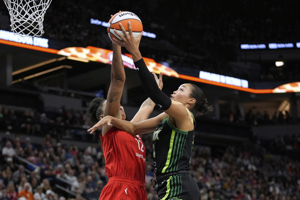 Minnesota Lynx forward Napheesa Collier (24) goes up for a shot as Indiana Fever forward Damiris Dantas (12) defends during the first half of a WNBA basketball game Sunday, Aug. 24, 2025, in Minneapolis. (AP Photo/Abbie Parr)