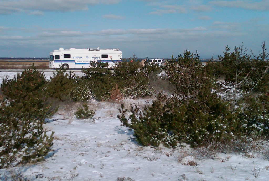 FILE - Suffolk County Police conduct a search, Tuesday, Dec. 14, 2010, along a beachfront road in Babylon, N.Y., where four bodies were found during a hunt for a missing New Jersey woman. (AP Photo/Frank Eltman, File)