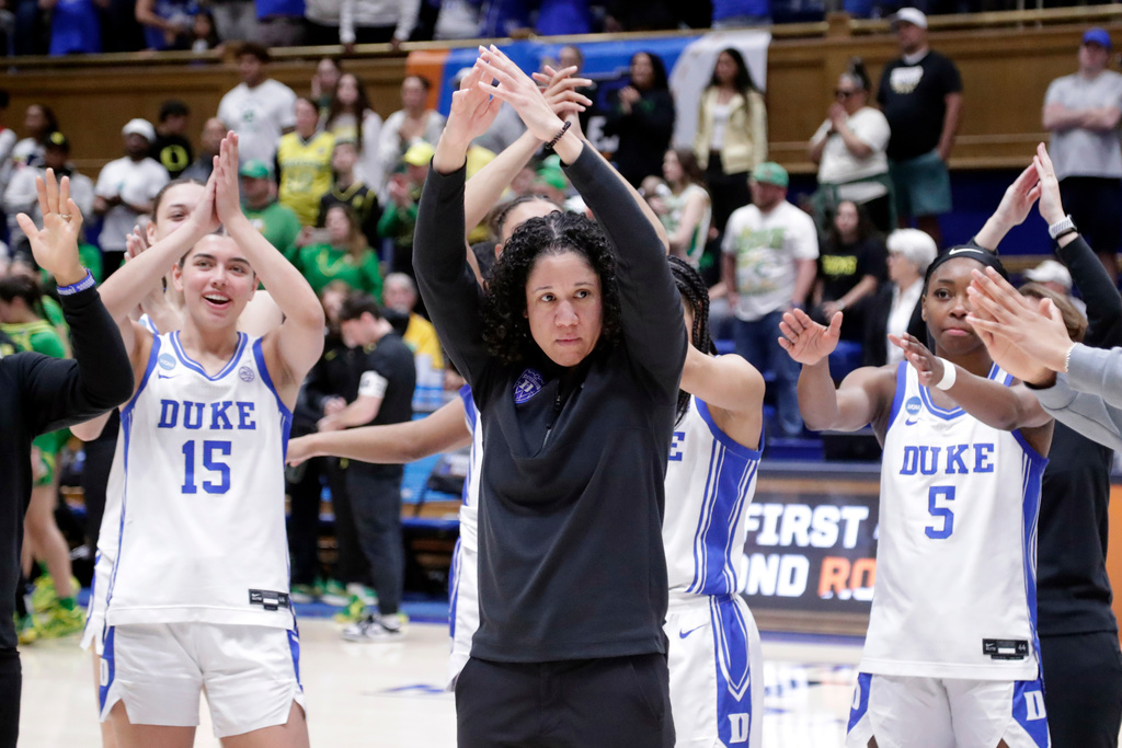 FILE - Duke head coach Kara Lawson, center, and her players celebrate after they defeated Oregon in the second round of the NCAA college basketball tournament Sunday, March 23, 2025, in Durham N.C. (AP Photo/Chris Seward, File)