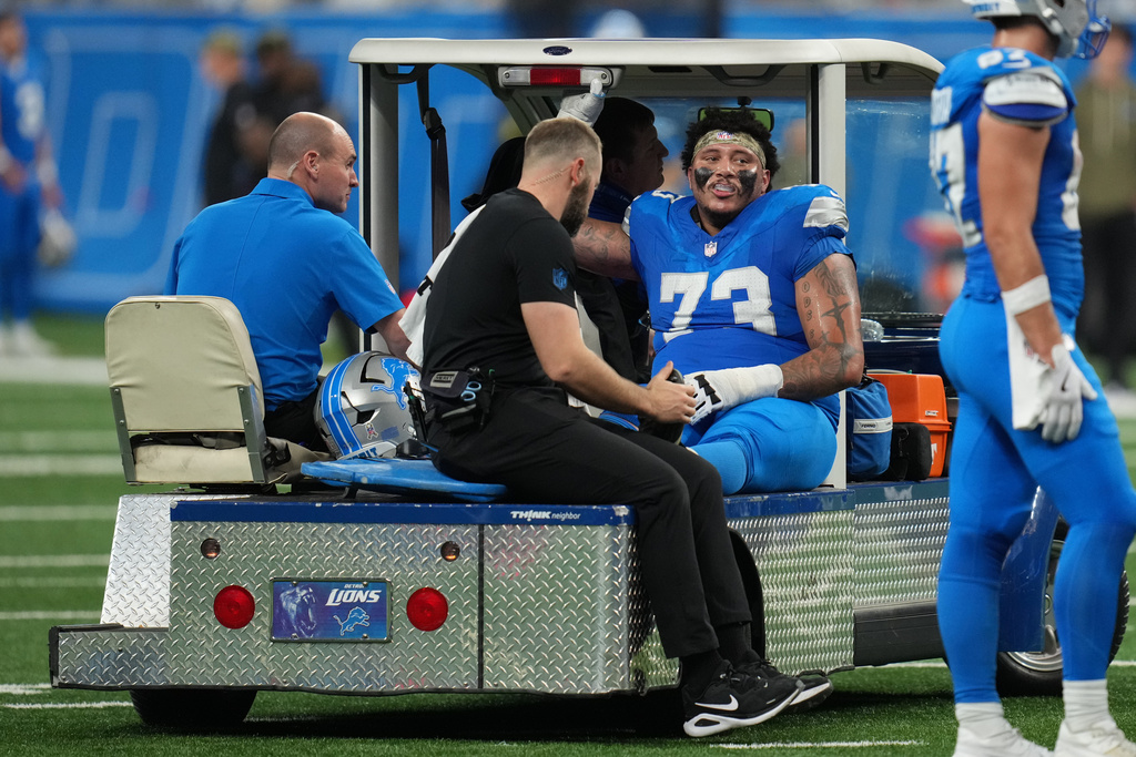 Detroit Lions guard Christian Mahogany (73) is carted off the field after sustaining an injury during the second half of an NFL football game against the Minnesota Vikings Sunday, Nov. 2, 2025, in Detroit. (AP Photo/Paul Sancya)