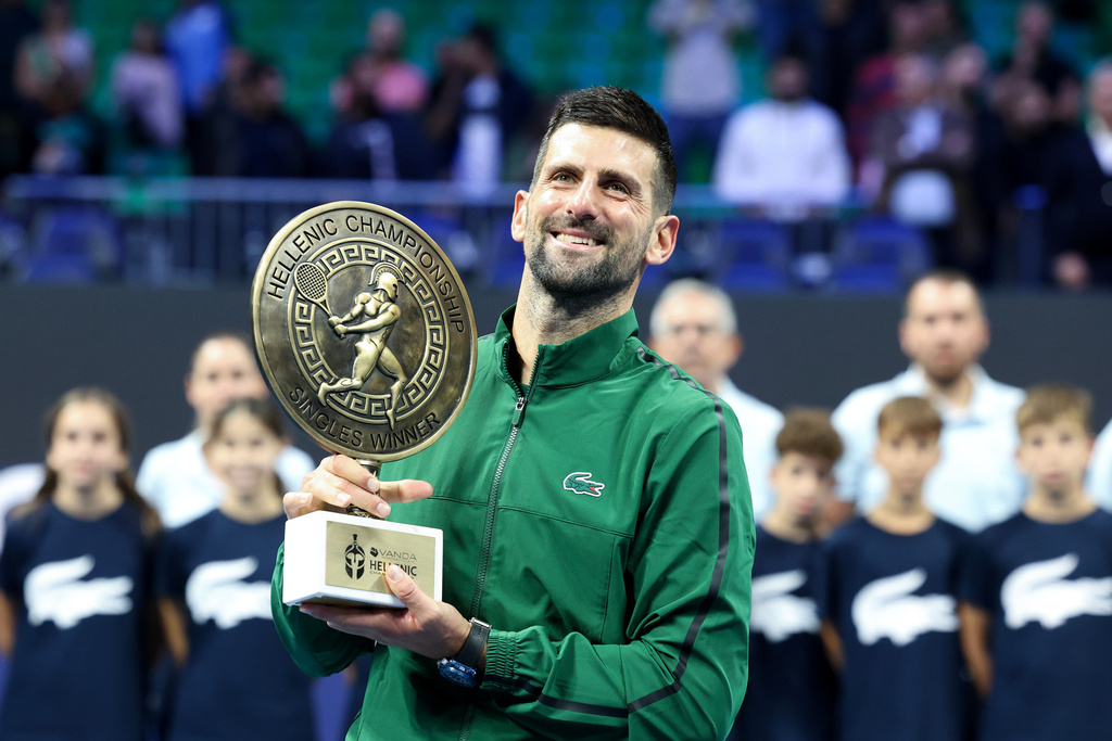 Novak Djokovic of Serbia raises the trophy of the ATP 250 tennis tournament after winning the final match against Lorenzo Musetti of Italy, in Athens, Greece, Saturday, Nov. 8, 2025. (AP Photo/Yorgos Karahalis)