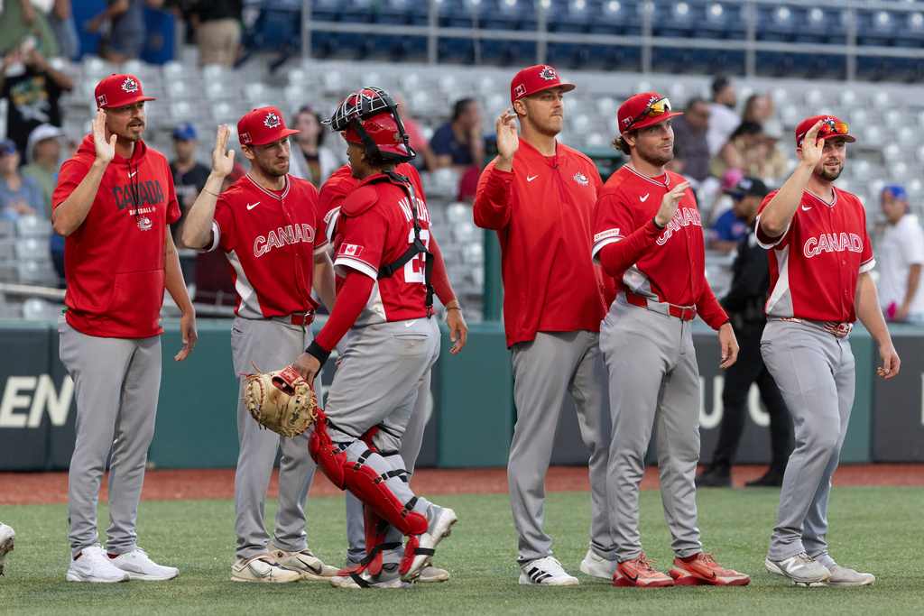 Canadian players celebrate at the end of a World Baseball Classic game Cuba in San Juan, Puerto Rico, Wednesday, March 11, 2026. (AP Photo/Alejandro Granadillo)