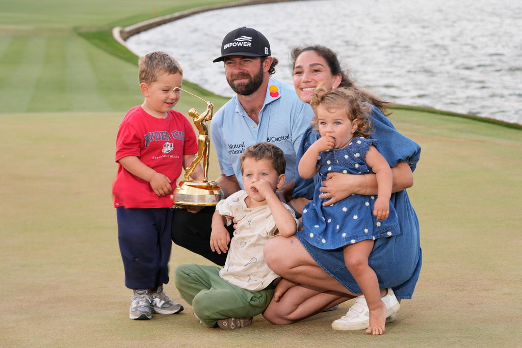 Cameron Young poses with his wife Kelsey, sons John, left, Henry and daughter Vivienne, after he won The Players Championship golf tournament Sunday, March 15, 2026, in Ponte Vedra Beach, Fla. (AP Photo/Gerald Herbert)