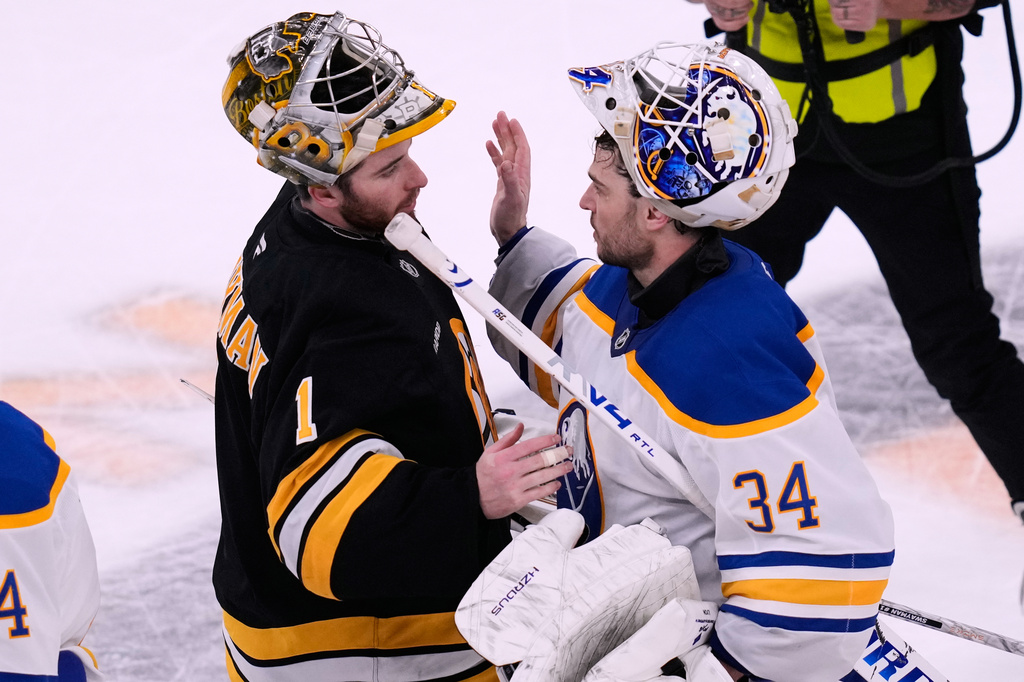 Boston Bruins goaltender Jeremy Swayman (1) congratulates Buffalo Sabres goaltender Alex Lyon (34) after the Sabres eliminated the Bruins from the playoffs following Game 6 of a first-round NHL hockey Stanley Cup playoff series, Friday, May 1, 2026, in Boston. (AP Photo/Charles Krupa)