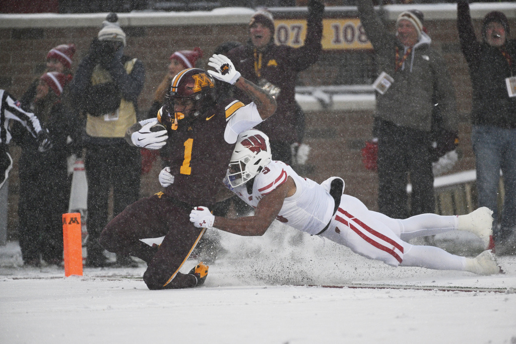 Minnesota running back Darius Taylor scores a touchdown during the first half of an NCAA college football game against Wisconsin Saturday, Nov. 29, 2025, in Minneapolis. (AP Photo/Tom Baker)