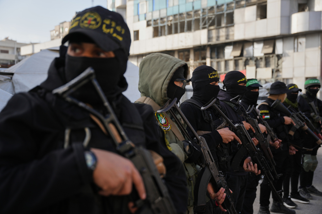 FILE - Armed Palestinian militants from Hamas and Islamic Jihad gather next to Eid al-Fitr prayers in Gaza City, March 20, 2026. (AP Photo/Abdel Kareem Hana, File)