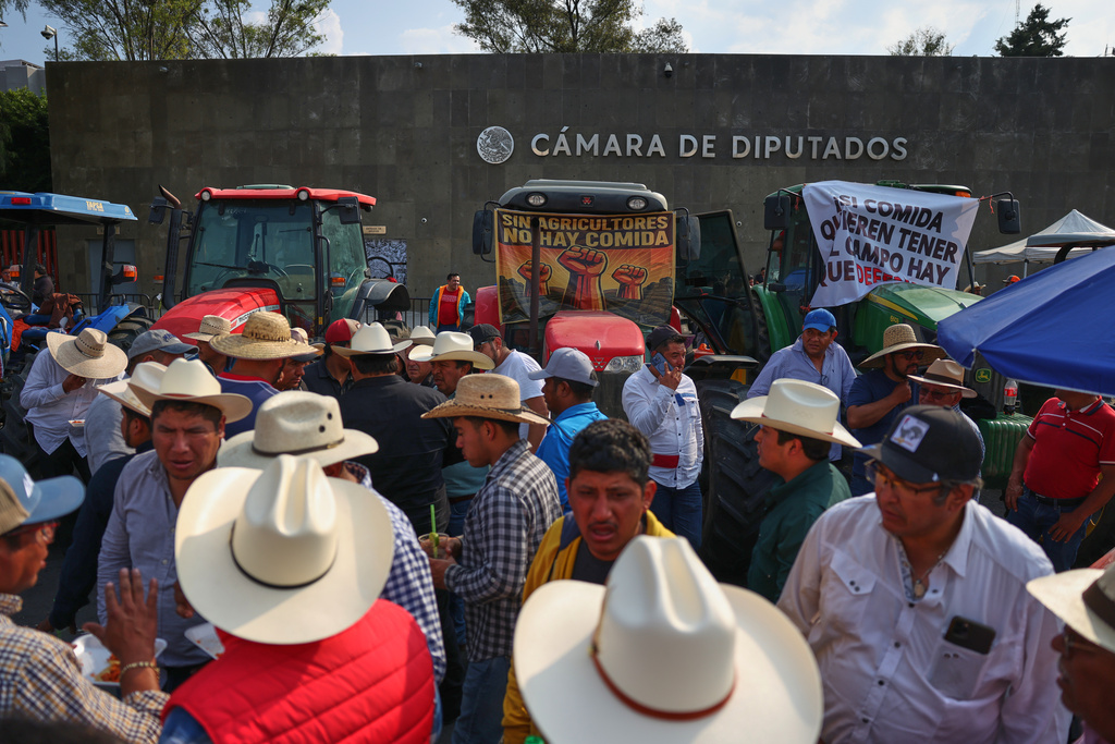Farmers protest a proposed water law outside the Chamber of Deputies in Mexico City, Wednesday, Dec. 3, 2025. (AP Photo/Claudia Rosel)