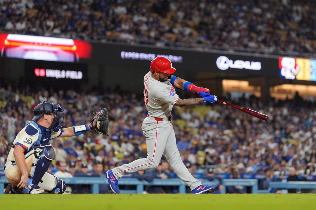 Philadelphia Phillies' Edmundo Sosa, right, hits a two-run home run as Los Angeles Dodgers catcher Will Smith watches during the eighth inning of a baseball game Saturday, May 30, 2026, in Los Angeles. (AP Photo/Mark J. Terrill)
