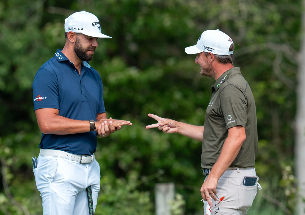 Erik Van Rooyen, left, of South Africa, and Emiliano Grillo, right, of Argentina, play 'Rock, Paper, Scissors' on the 16th green during the first round of the Canadian Open golf tournament in Caledon, Ontario, Thursday, June 11, 2026. (Frank Gunn/The Canadian Press via AP)