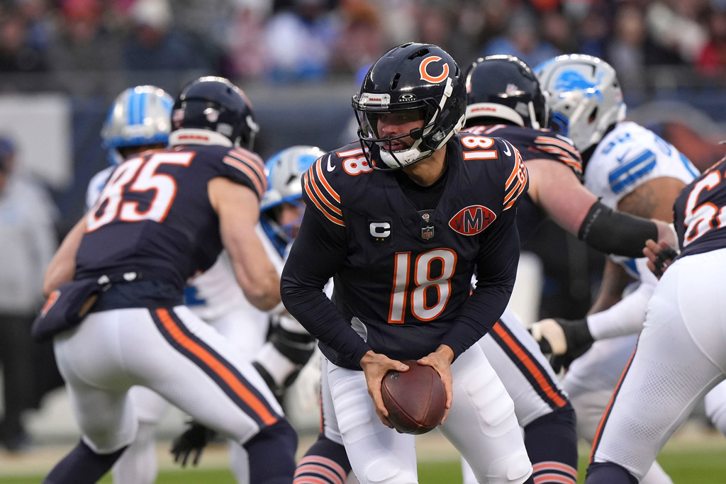 Chicago Bears quarterback Caleb Williams (18) looks to hand the ball off during the first half of an NFL football game against the Detroit Lions, Sunday, Jan. 4, 2026, in Chicago. (AP Photo/Nam Y. Huh)
