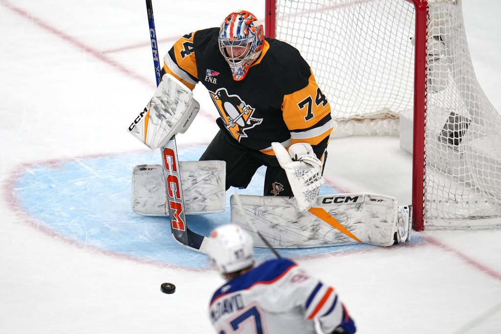 Edmonton Oilers' Connor McDavid (97) has a shot blocked by Pittsburgh Penguins goalie Stuart Skinner (74) during the first period of an NHL hockey game in Pittsburgh, Tuesday, Dec. 16, 2025. (AP Photo/Gene J. Puskar)