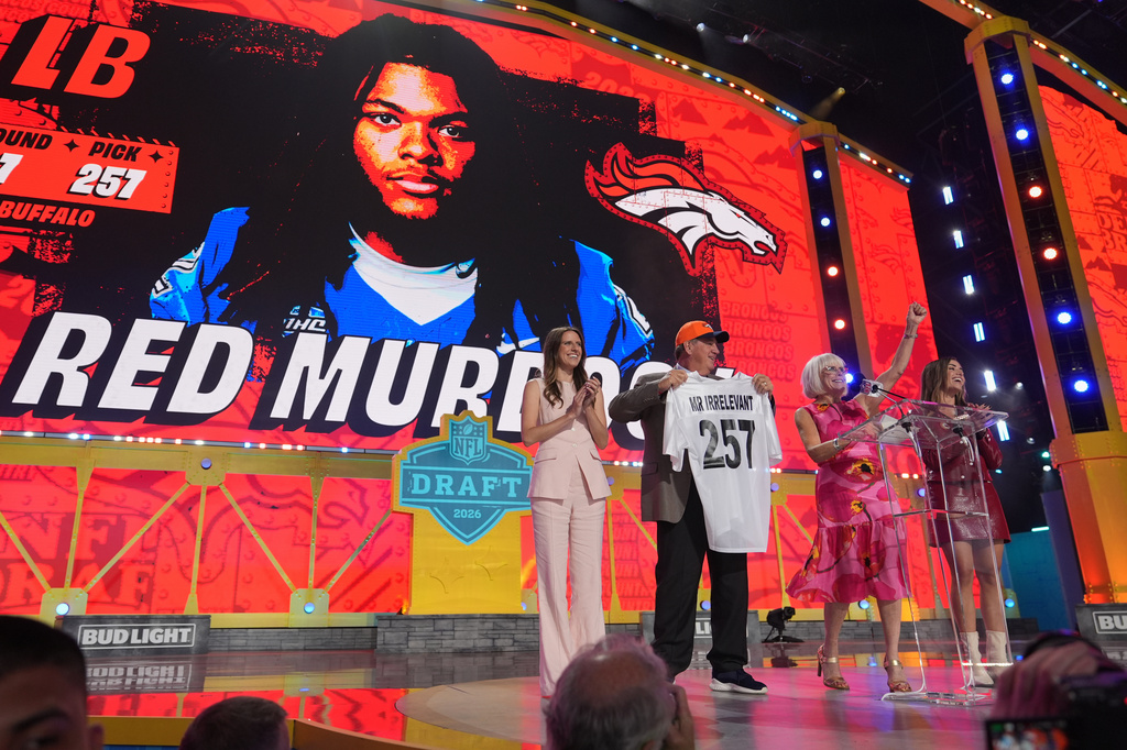 Melanie Salata Fitch, second from right announces Red Murdock as the final pick, referred to as Mr. Irrelevant, by the Denver Broncos, during third day of the NFL football draft, Saturday, April 25, 2026, in Pittsburgh. (AP Photo/Jeff Roberson)