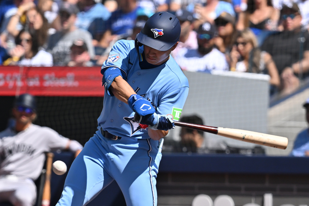 Toronto Blue Jays' Brett Bateman (21) hits a single against the New York Yankees during the first inning of a baseball game in Toronto, Saturday, Aug. 15, 2026. (Jon Blacker/The Canadian Press via AP)