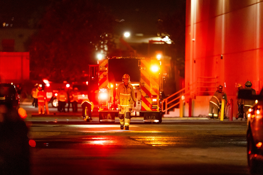 First responders work the scene after a helicopter crashed near a bus crash in Chatsworth, a neighborhood in Los Angeles, Tuesday, Sept. 15, 2026. (AP Photo/Ethan Swope)
