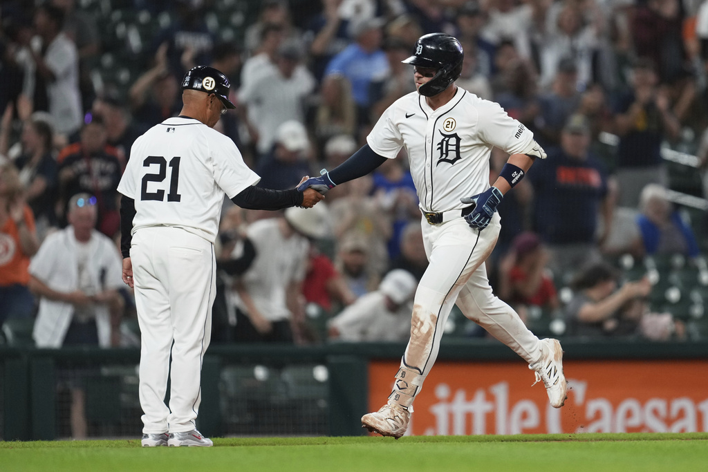 Detroit Tigers' Spencer Torkelson celebrates his two-run home run with third base coach Joey Cora (56) during the 10th inning of a baseball game against the Cleveland Guardians Tuesday, Sept. 16, 2025, in Detroit. (AP Photo/Paul Sancya)
