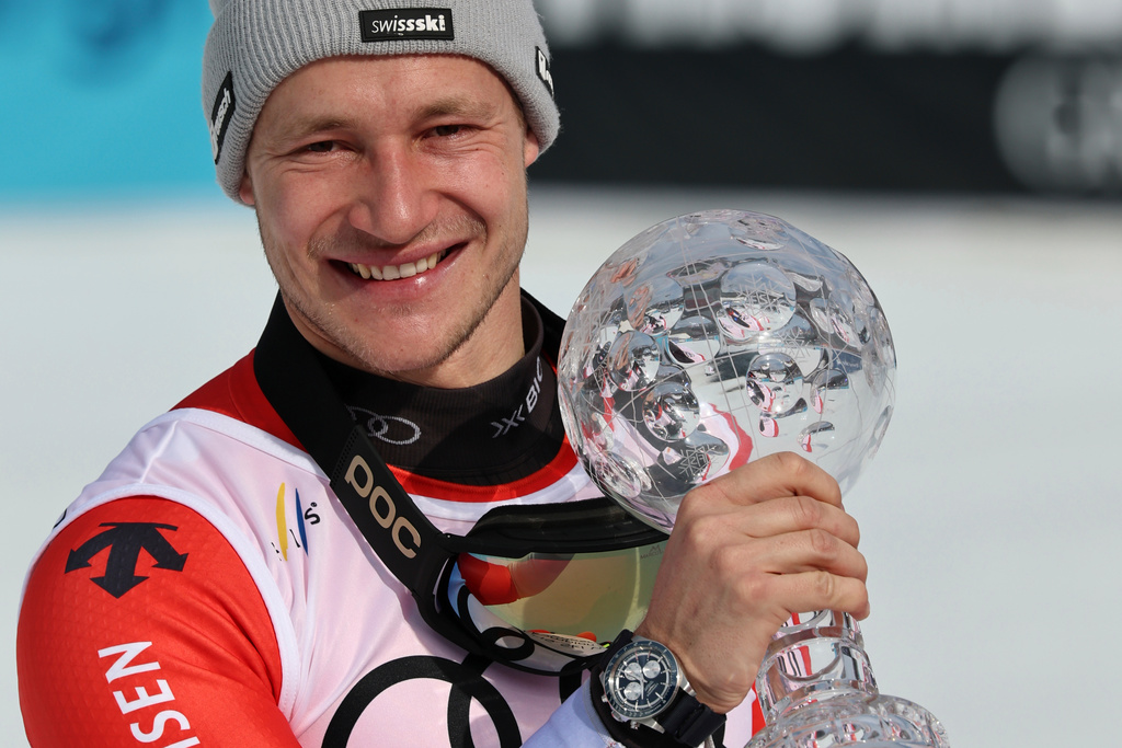 Switzerland's Marco Odermatt shows the globe trophy for the super-G discipline title at the finish area of an alpine ski, men's super-G race, at the Lillehammer World Cup Finals, in Kvitfjell, Norway, Sunday, March 22, 2026. (AP Photo/Marco Trovati)