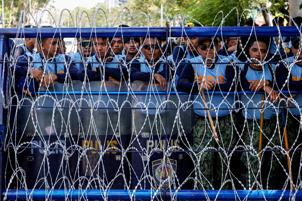 Philippine police personnel gather for deployment to secure the the Senate in Pasay city, Philippines, Monday, July 6, 2026, ahead of the impeachment trial of Duterte. (AP Photo/Gerard Carreon)