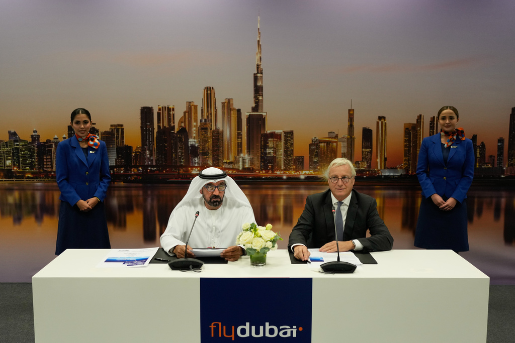 Sheikh Ahmed bin Saeed Al Maktoum, the chairman and chief executive of Emirates and chairman of FlyDubai speaks as Airbus' CEO of commercial aircraft Christian Scherer, right, looks on at a press conference to announce an order for 150 Airbus A321neo aircraft at the Dubai Air Show, United Arab Emirates, Tuesday, Nov. 18, 2025. (AP Photo/Altaf Qadri)