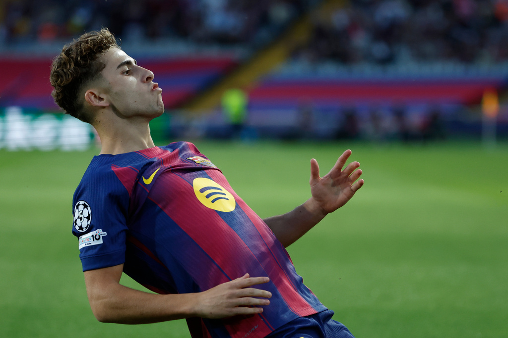 Barcelona's Fermin Lopez celebrates after scoring the opening goal of his team during the Champions League opening phase soccer match between Barcelona and Olympiacos in Barcelona, Spain, Tuesday, Oct. 21, 2025. (AP Photo/Joan Monfort)