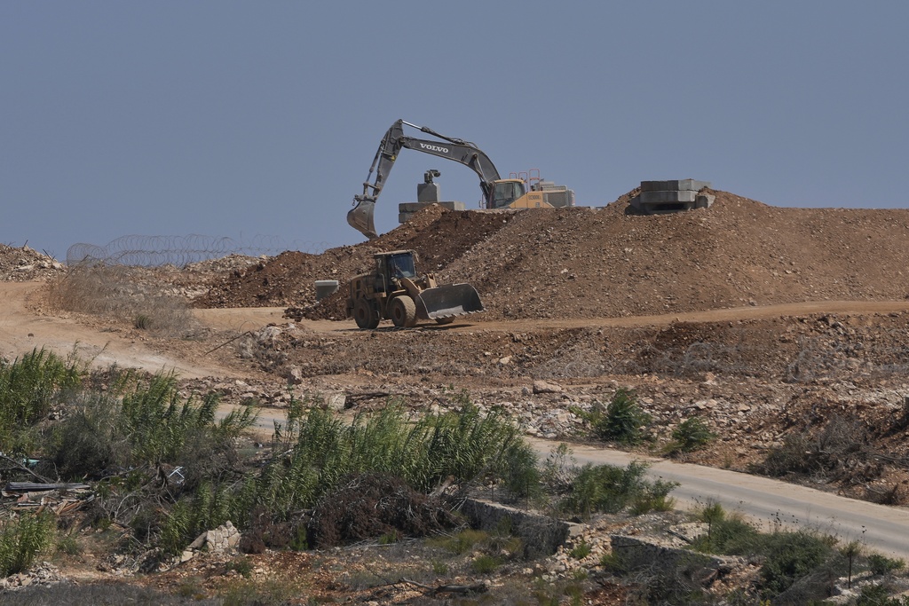 Israeli bulldozers work at one of five new positions the Israeli army established inside Lebanese territory along a road between Houla and Kfar Kila, border villages destroyed by Israeli airstrikes and a ground offensive, in south Lebanon, Wednesday, Aug. 20, 2025. (AP Photo/Hussein Malla)
