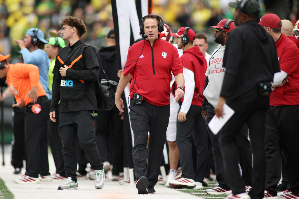 Indiana head coach Curt Cignetti, center, walks the sideline during the first half of an NCAA college football game against Oregon, Saturday, Oct. 11, 2025, in Eugene, Ore. (AP Photo/Lydia Ely)