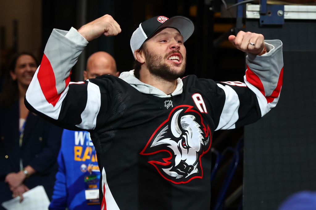 Buffalo Bills quarterback Josh Allen hypes the crowd prior to the first period in Game 2 of a first-round NHL hockey Stanley Cup playoff series between the Buffalo Sabres and Boston Bruins Tuesday, April 21, 2026, in Buffalo, N.Y. (AP Photo/Jeffrey T. Barnes)