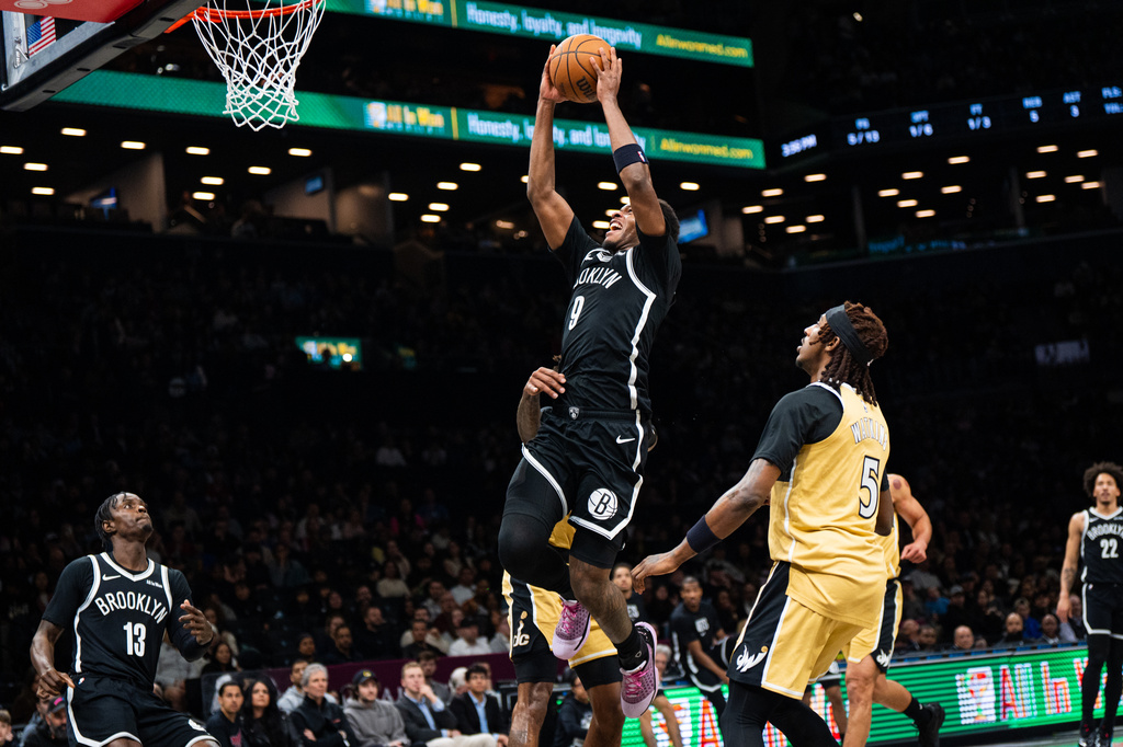 Brooklyn Nets forward E.J. Liddell (9) goes for a dunk during the first half of an NBA basketball game against the Washington Wizards, Sunday, April 5, 2026, in New York. (AP Photo/Angelina Katsanis)