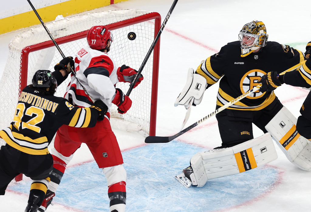 Boston Bruins goalie Jeremy Swayman eyes the puck that Carolina Hurricanes forward Mark Jankowski (77) could not get past him in the third period of an NHL hockey game, Saturday, Nov. 1, 2025, in Boston. (AP Photo/Jim Davis)