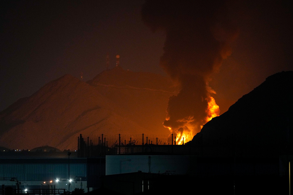 Large fire and plume of smoke is visible after, according to the authorities, debris of an Iranian intercepted drone hit the Fujairah oil facility, in Fujairah, United Arab Emirates, Tuesday, March 3, 2026. (AP Photo/Altaf Qadri)