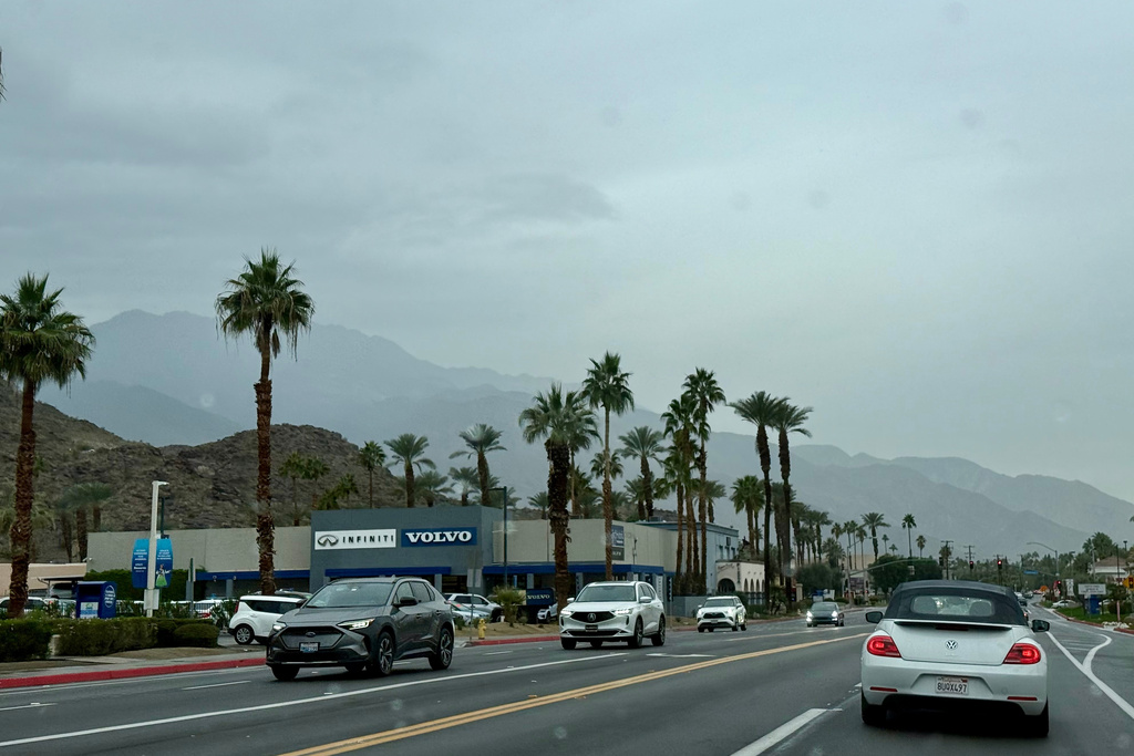 Drivers make their way in the rain on East Palm Canyon Drive, Tuesday, Dec. 23, 2025, in Palm Springs, Calif. (AP Photo/Pamela Hassell)