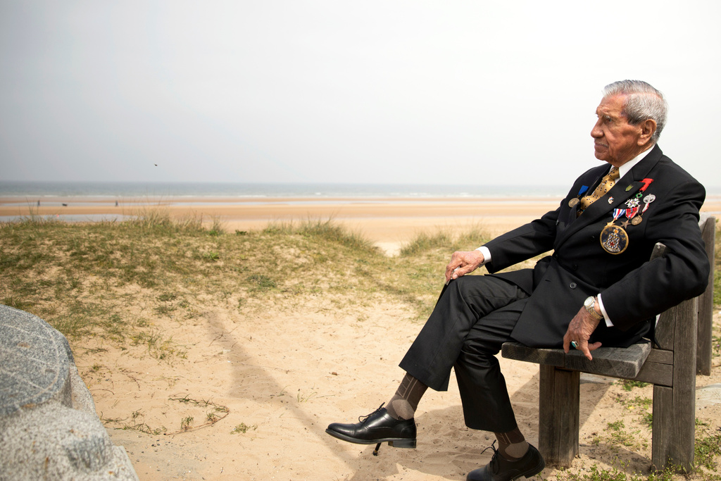 FILE - World War II and D-Day veteran Charles Norman Shay, from Maine, poses at the Charles Shay monument on Omaha Beach in Normandy, France, Wednesday, May 1, 2019. Shay was a combat medic assigned to an assault battalion in the first wave of attack on D-Day, June 6, 1944. (AP Photo/Virginia Mayo, File)