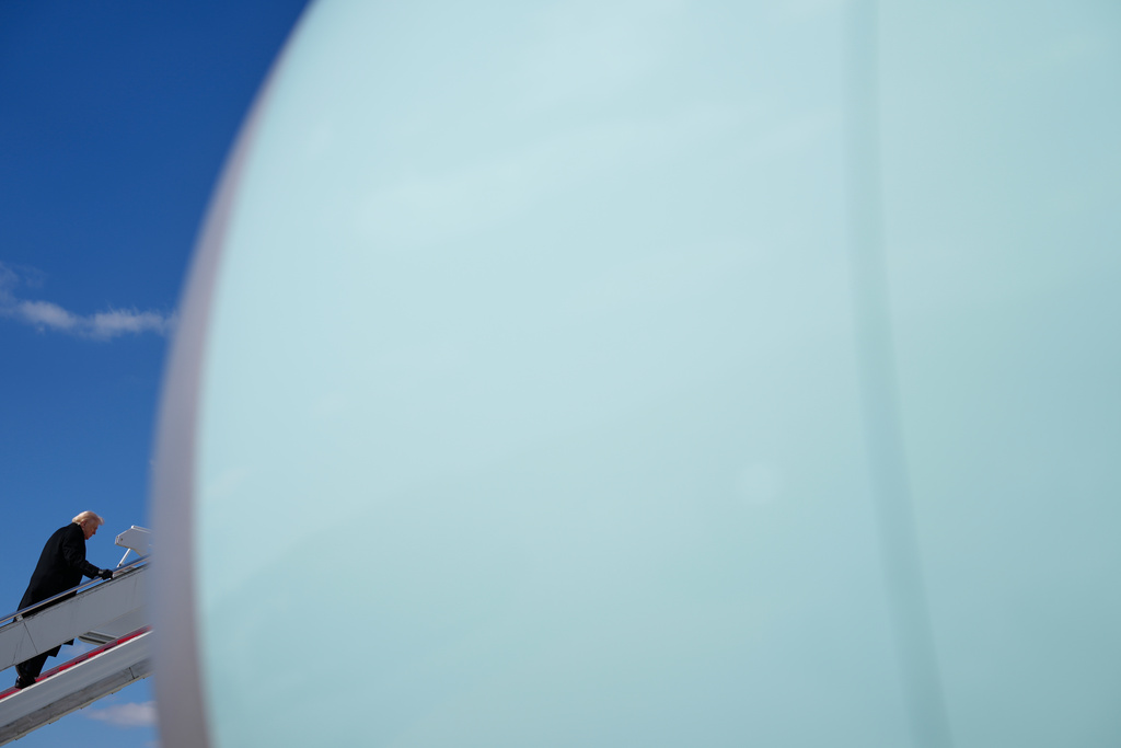 President Donald Trump boards Air Force One, Wednesday, March 18, 2026, at Dover Air Force Base, Del., after attending the casualty return for the six crew members of an Air Force refueling aircraft who died when their plane crashed in western Iraq while supporting operations against Iran. (AP Photo/Julia Demaree Nikhinson)