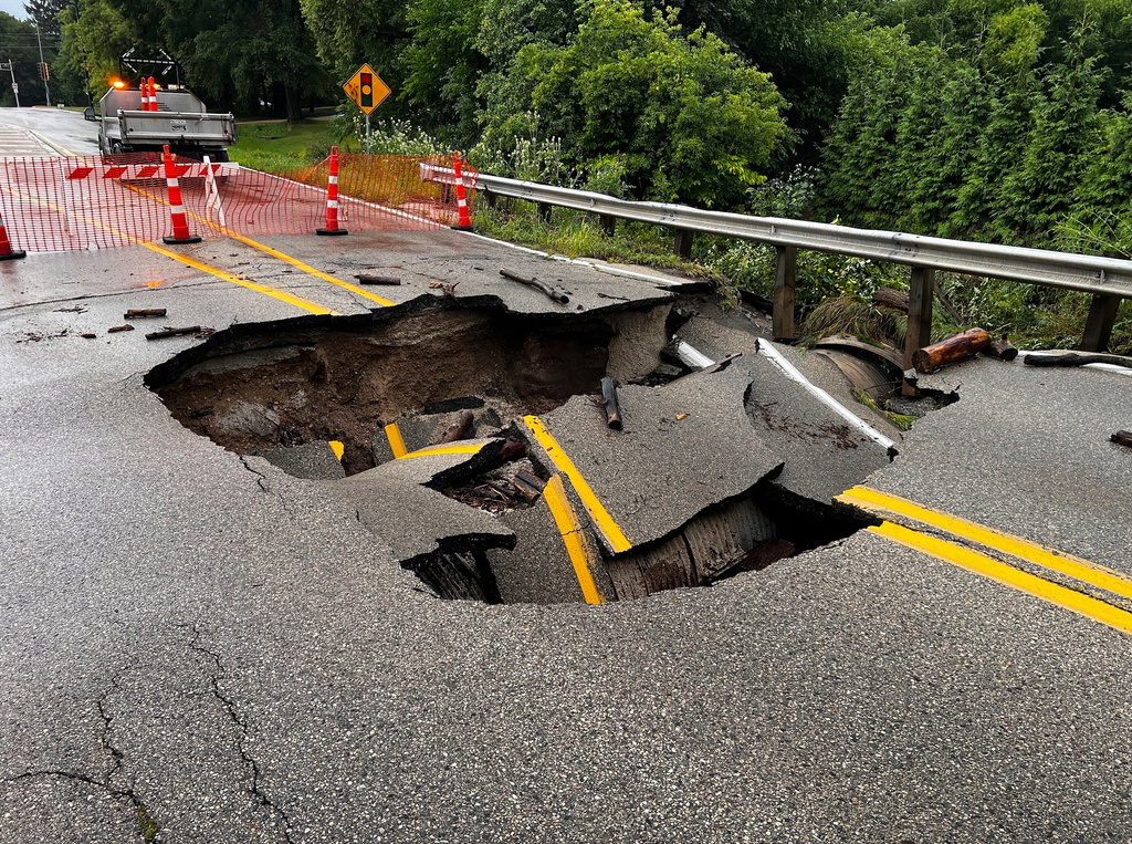 CORRECTION - CORRECTS SOURCE TO CBS58 NOT CBS28. This image provided by CBS58 (WDJT) shows a damaged street as a result of flooding in the area in Milwaukee, Sunday, Aug. 10, 2025. (CBS58 (WDJT) via AP)