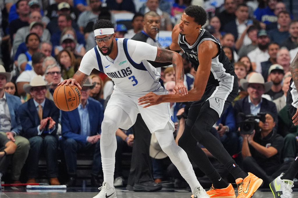 Dallas Mavericks forward Anthony Davis (3) dribbles against San Antonio Spurs forward Victor Wembanyama (1) during the first half of an NBA basketball game in Dallas, Wednesday, Oct. 22, 2025. (AP Photo/LM Otero)