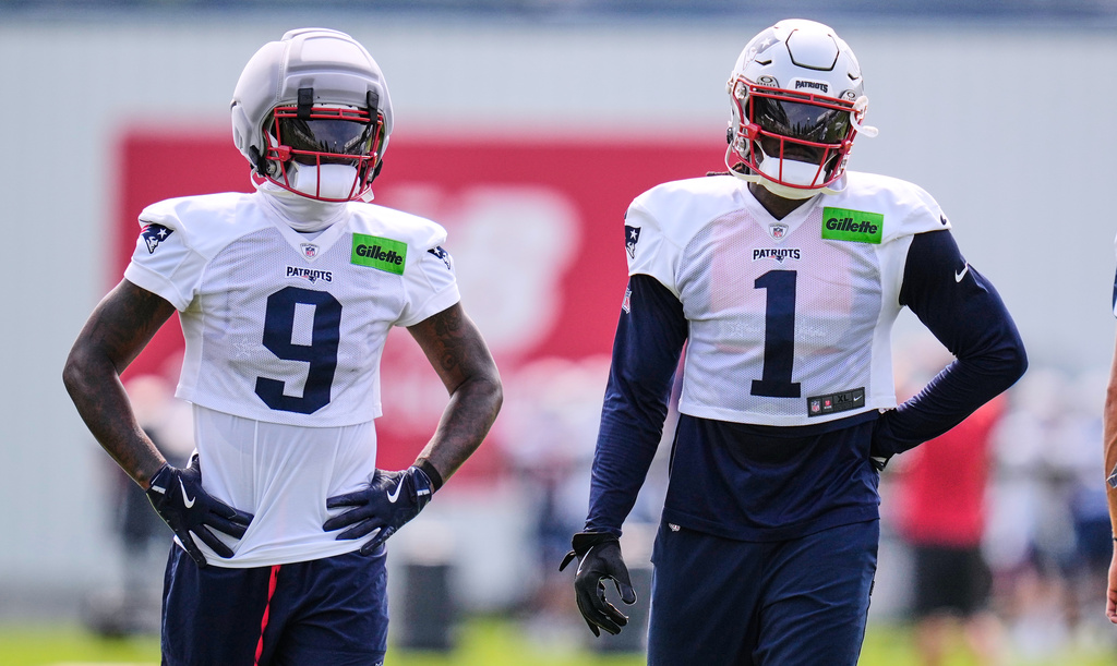 New England Patriots wide receivers A.J. Brown (1) and Kayshon Boutte (9) wait their turn on a drill during the team's NFL football training camp, Monday, Aug. 10, 2026, in Foxborough, Mass. (AP Photo/Charles Krupa)