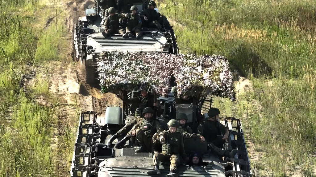 In this photo taken from video distributed by Russian Defense Ministry Press Service on Friday, Sept. 12, 2025, Armored vehicles drive during joint military drills held by Russia and Belarus. (Russian Defense Ministry Press Service via AP)