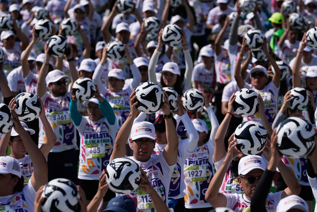 People practice soccer skills in an attempt to set a Guinness World Record for the "largest soccer class" at the Zocalo in Mexico City, Sunday, March 15, 2026. (AP Photo/Marco Ugarte)