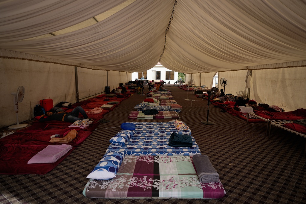 Mattresses are laid out for stranded travelers inside a tent at a farmhouse owned by an Indian businessman, now converted into a shelter in Ajman, near Dubai, United Arab Emirates, Saturday, March 7, 2026. (AP Photo/Altaf Qadri)