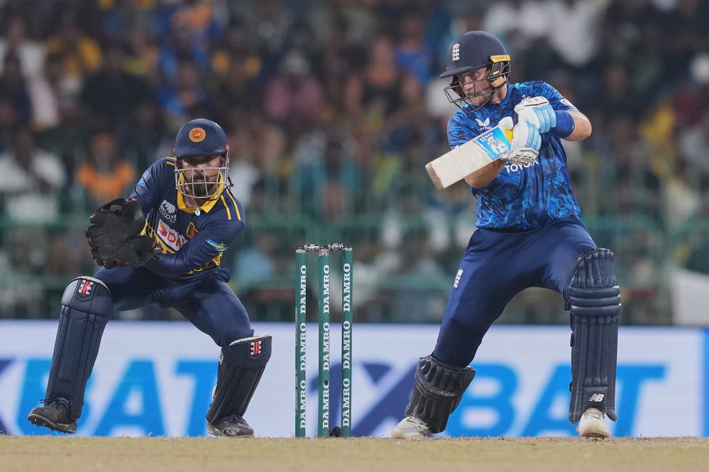 England's Joe Root plays a shot as Sri Lanka's Kusal Mendis watches during the second ODI cricket match between England and Sri Lanka in Colombo, Sri Lanka, Saturday, Jan. 24, 2026. (AP Photo/Eranga Jayawardena)