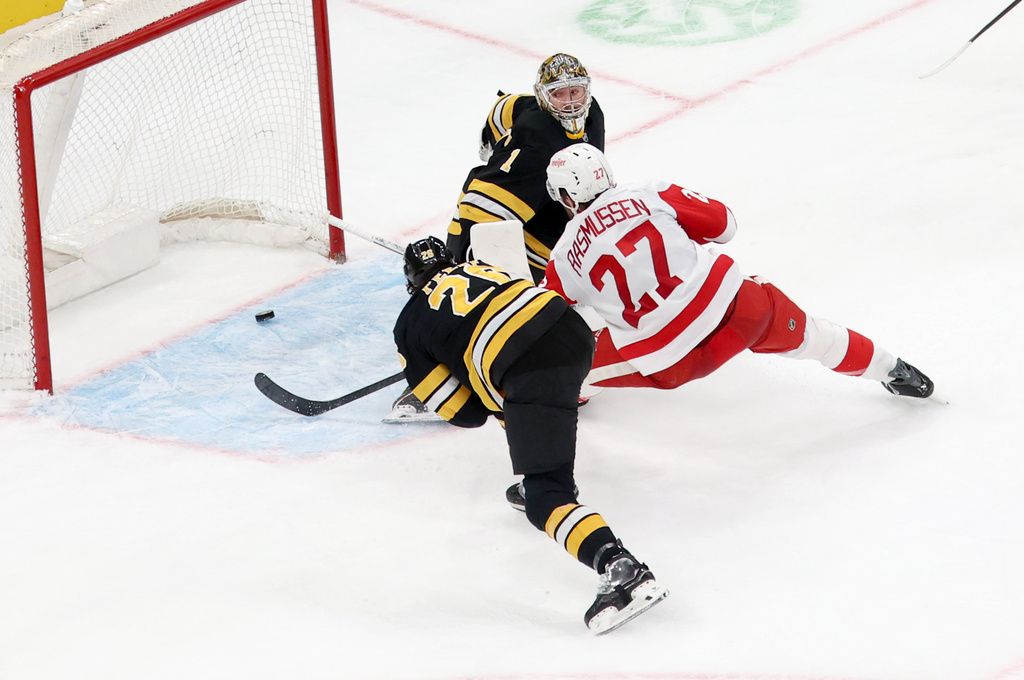 Detroit Red Wings center Michael Rasmussen (27) scores against Boston Bruins goaltender Jeremy Swayman (1) during the third period of an NHL hockey game, Saturday, Nov. 29, 2025, in Boston. (AP Photo/Mark Stockwell)