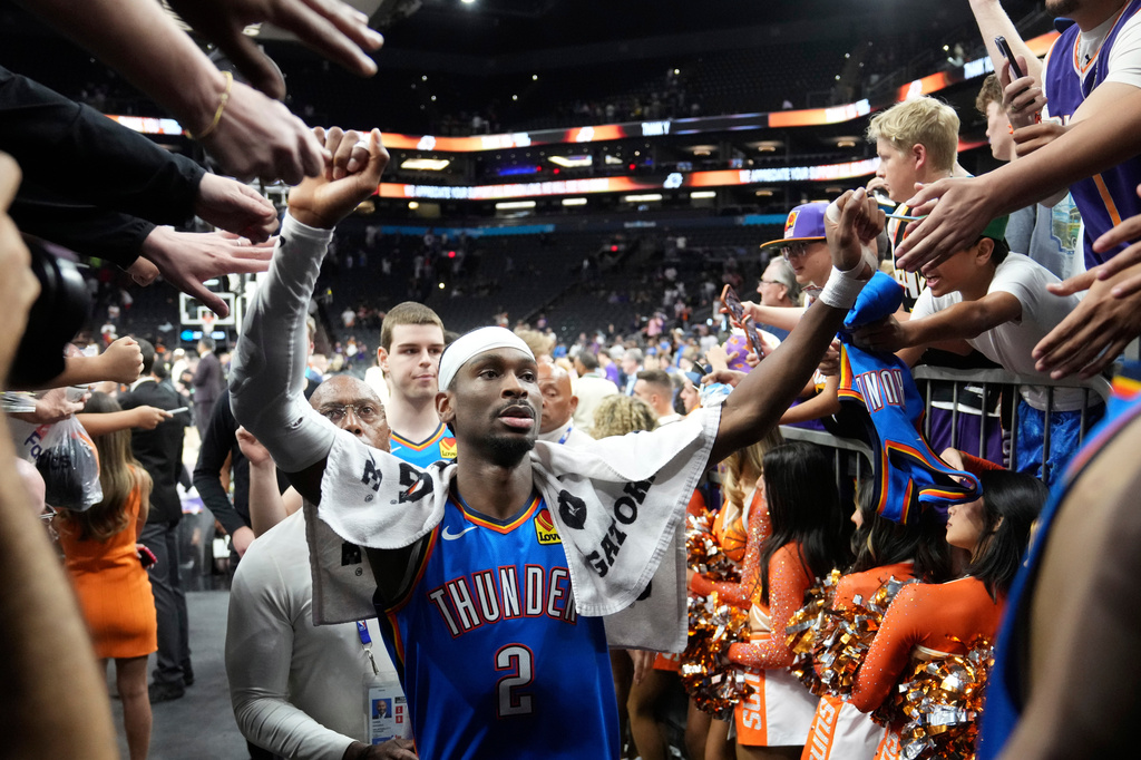 Oklahoma City Thunder guard Shai Gilgeous-Alexander celebrates with fans after Game 4 in a first-round NBA playoffs basketball series against the Phoenix Suns, Monday, April 27, 2026, in Phoenix. (AP Photo/Ross D. Franklin)