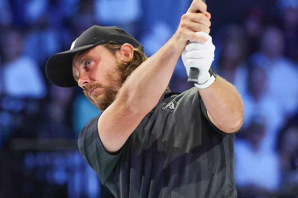 Tommy Fleetwood of the Jupiter Links Golf Club plays his shot from the second tee during the TGL finals golf tournament in Palm Beach Gardens, Fla., Tuesday, March 24, 2026. (AP Photo/Reinhold Matay)